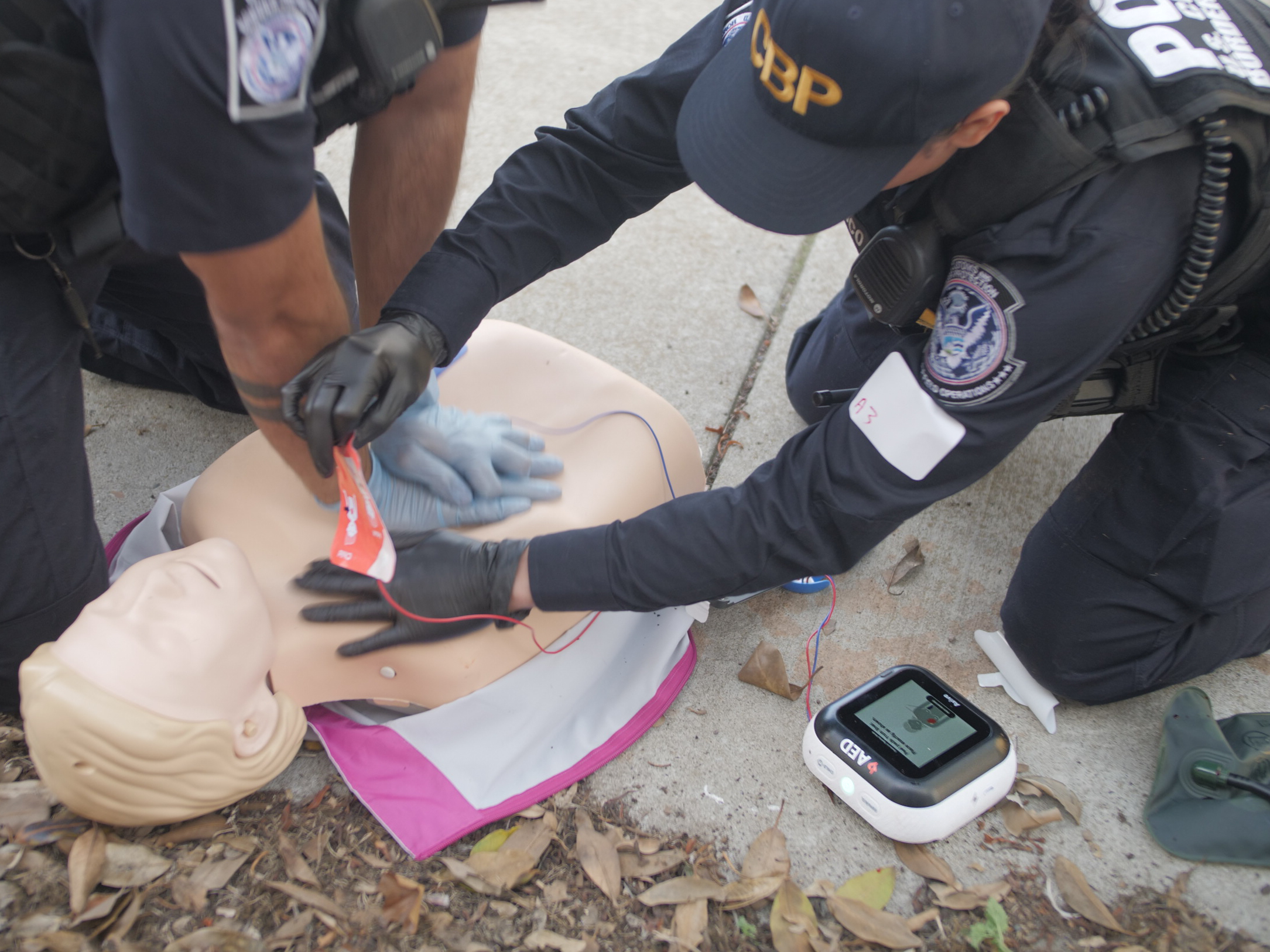 Police officers using the Avive Connect AED for CPR training. 